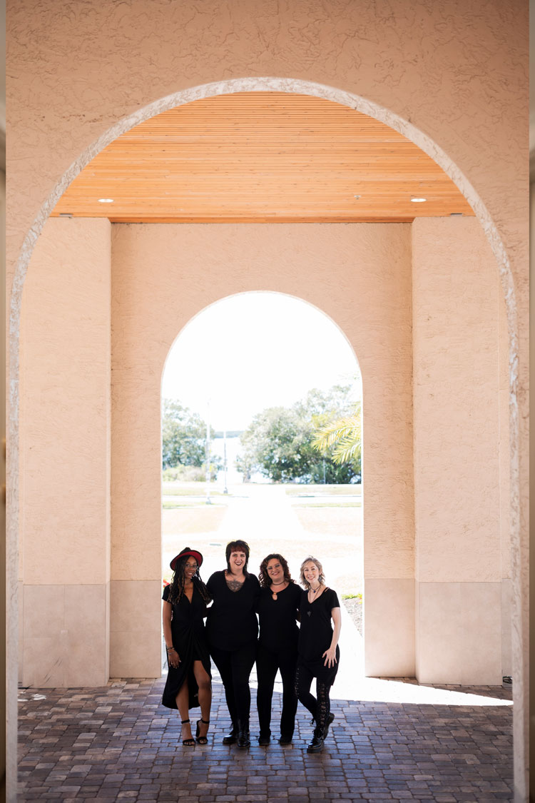 Peroxide team standing outside under an arch